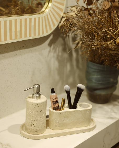 Aurum Dusk candle on a stone tray with jewellery