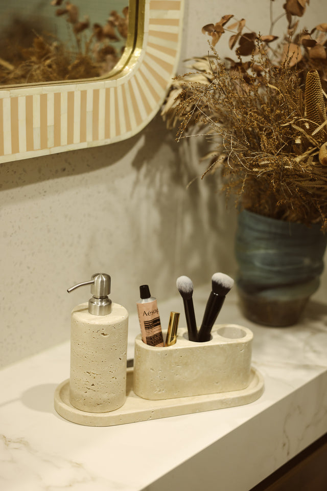 Aurum Dusk candle on a stone tray with jewellery