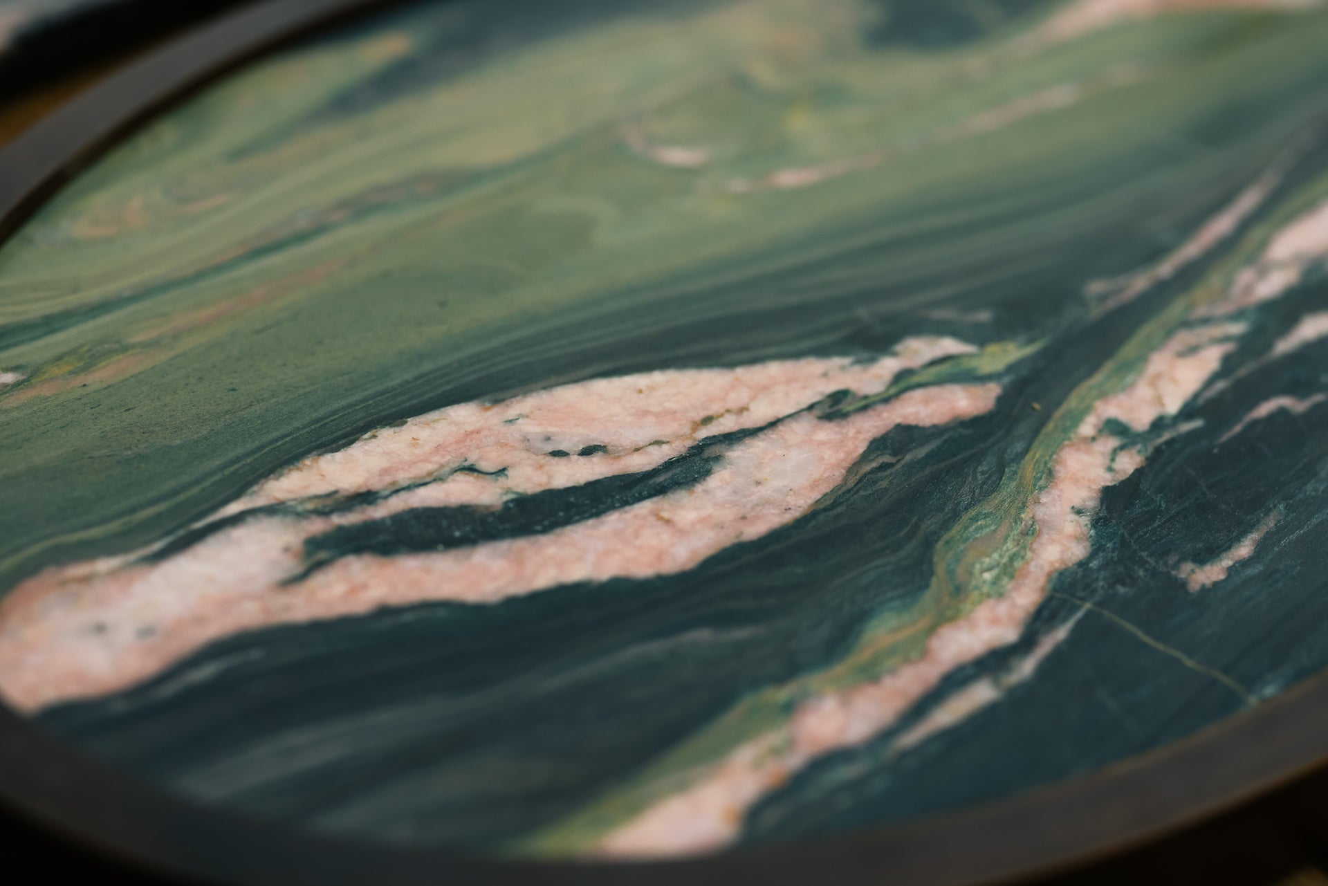 Close-up of green and pink natural stone, the backdrop for Epicuria's hero banner