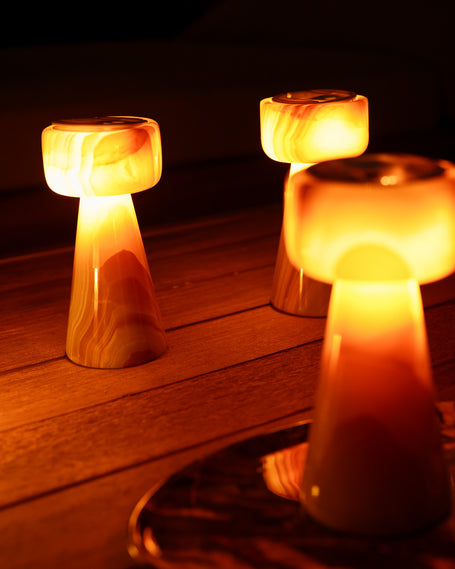 Caramel Swirl Onyx candle holders glowing at dusk
