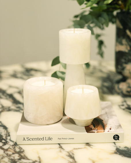 Alabaster White Onyx candles displayed on a marble surface