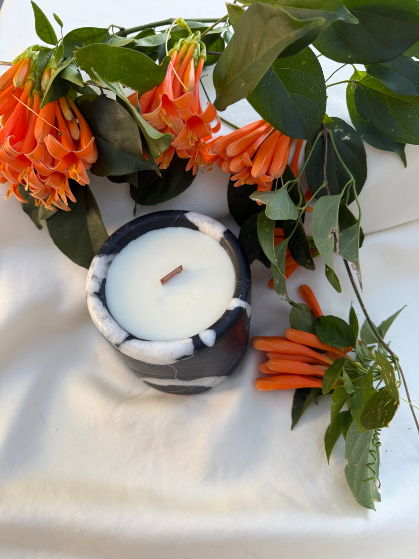 Natural stone trays holding lit tealight candles